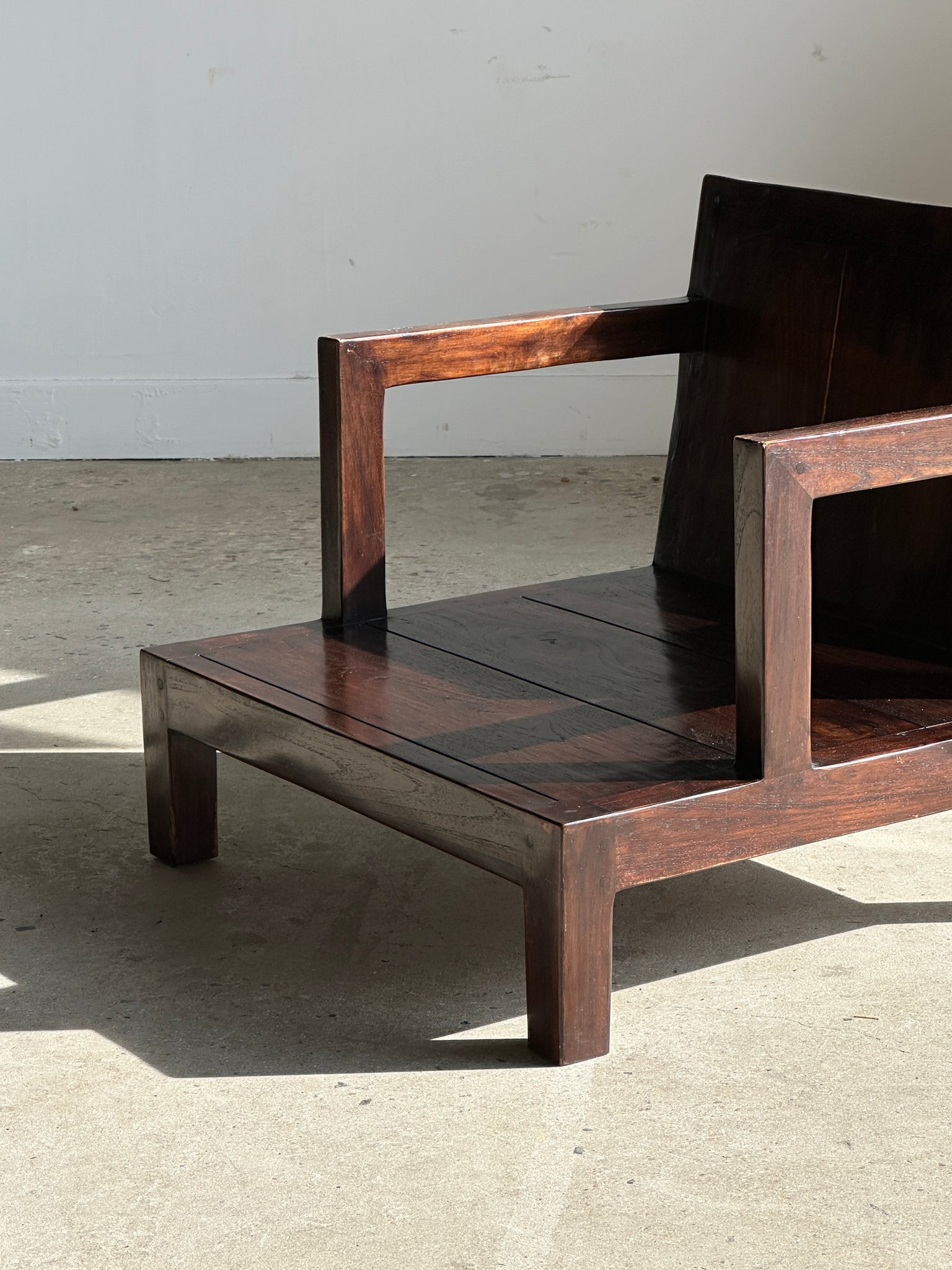 Petit fauteuil bas en bois brun verni
