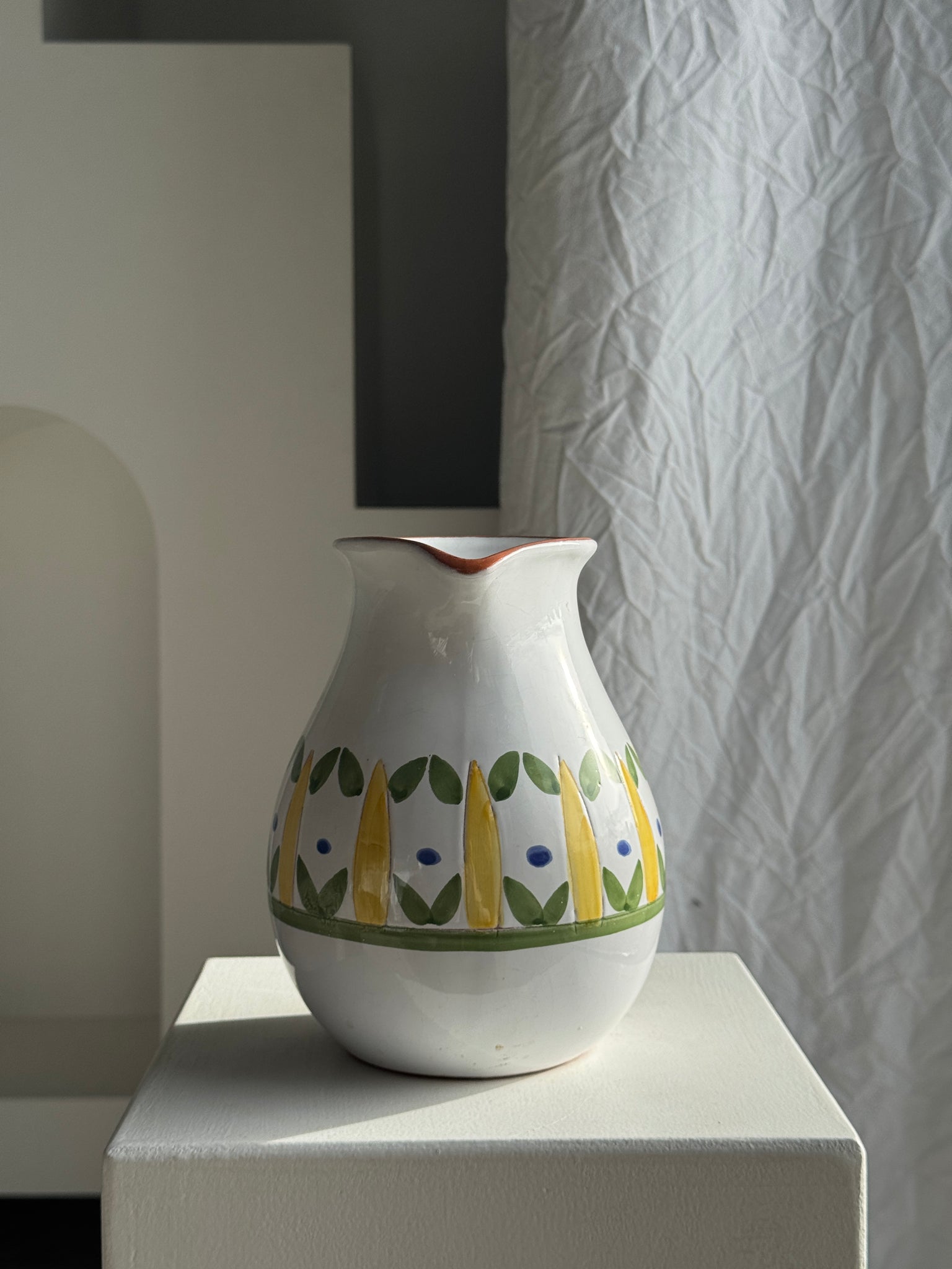 Grande carafe blanche en terre cuite à motif de frise stylisée verte jaune et bleue H20 D17